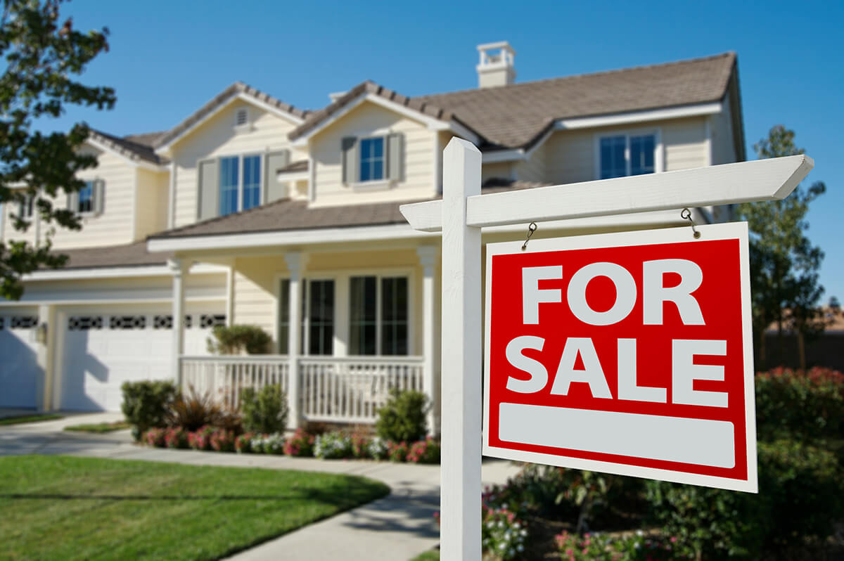 For sale sign in front of home